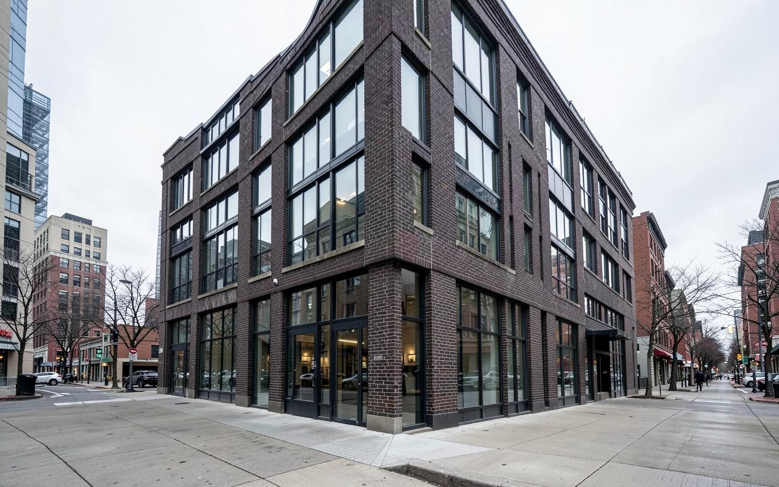 Modern brick and glass building exterior on a Toronto street corner